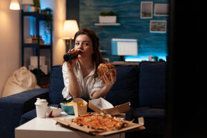 Why am I overweight, woman eating pizza